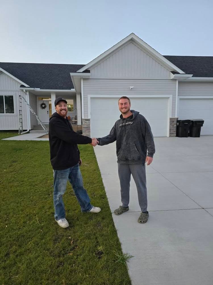 Derek shaking hands with a customer in their driveway