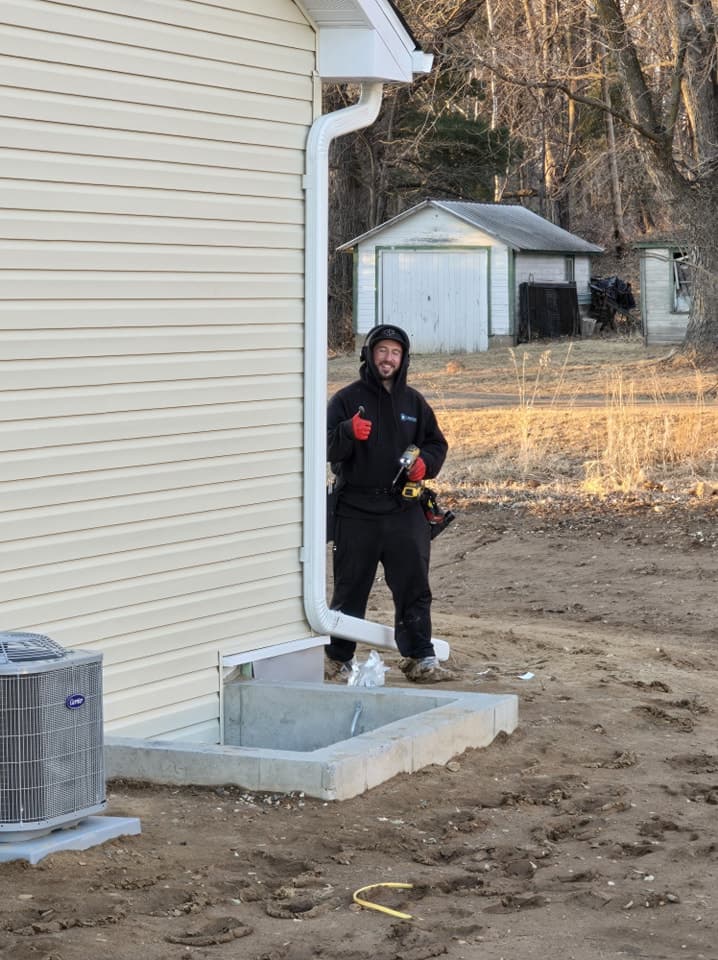 Gutter Butlers crew member installing a downspout